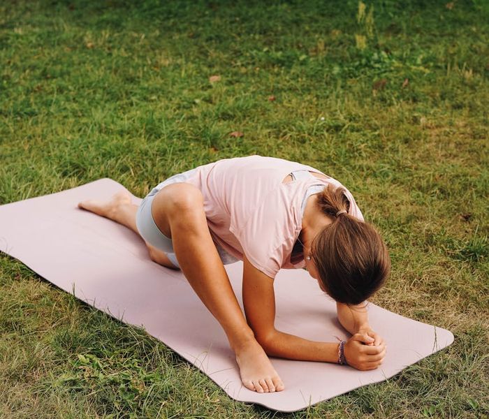 Woman stretching gracefully, embodying energy and flexibility in a serene setting.